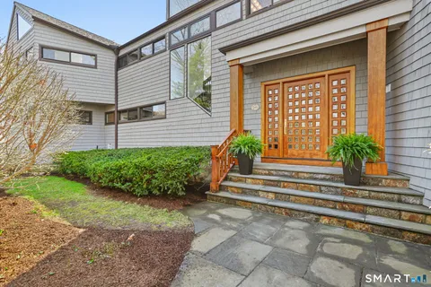 a living room with furniture fireplace and a large window