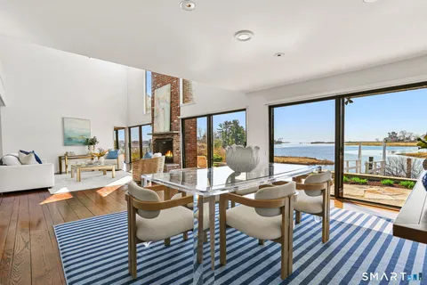 a living room with fireplace furniture and a rug