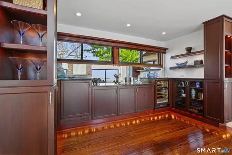 a dining room with furniture a fireplace and large windows