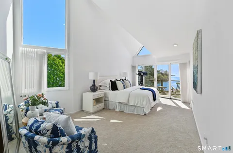 a view of a balcony with two chairs and a table