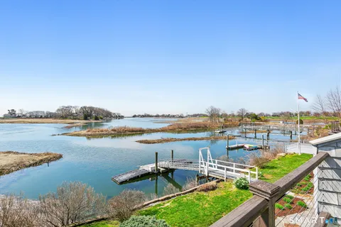 a view of a lake with furniture and city view
