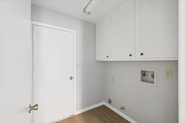 a view of a room with wooden floor