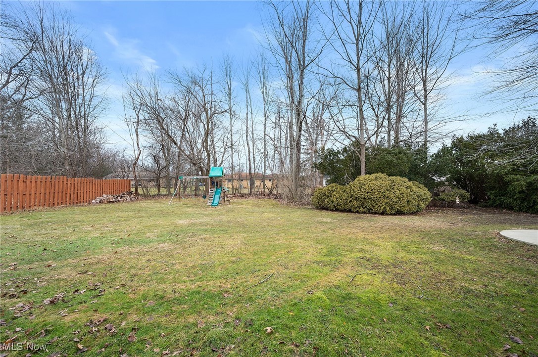 87 Kenridge Road Akron, OH 44333 - Photo 46 of 48 View of yard featuring fence and a playground
