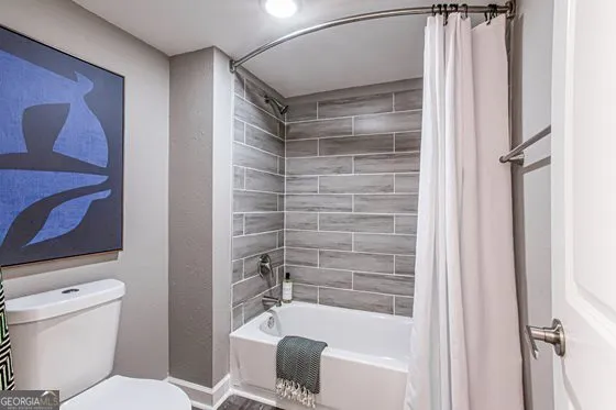 a bathroom with a shower and a toilet