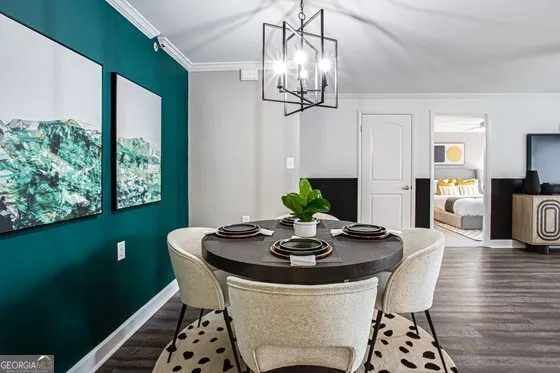 a view of a dining room with furniture a chandelier and wooden floor