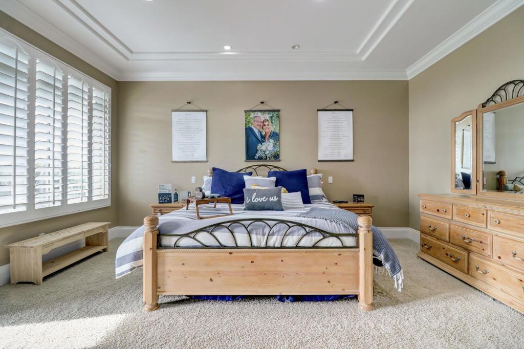 2801 Via Asoleado Alpine, CA 91901 - Photo 34 of 74 a spacious bedroom with a bed couch and window