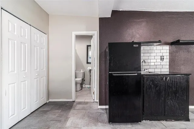 a kitchen with a refrigerator and window