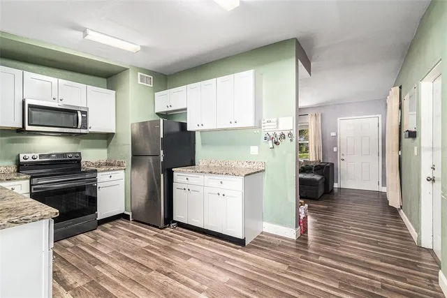 a kitchen with a refrigerator stove and sink