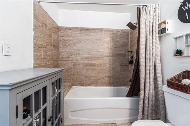 a bathroom with a granite countertop sink toilet and bathtub