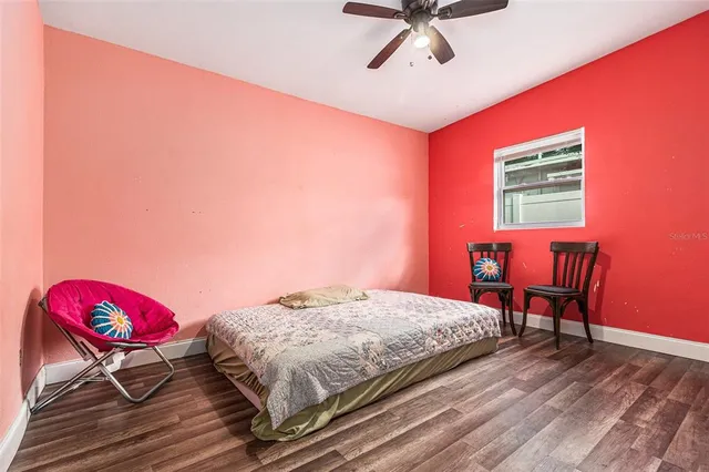 a bedroom with a bed a chair and couch