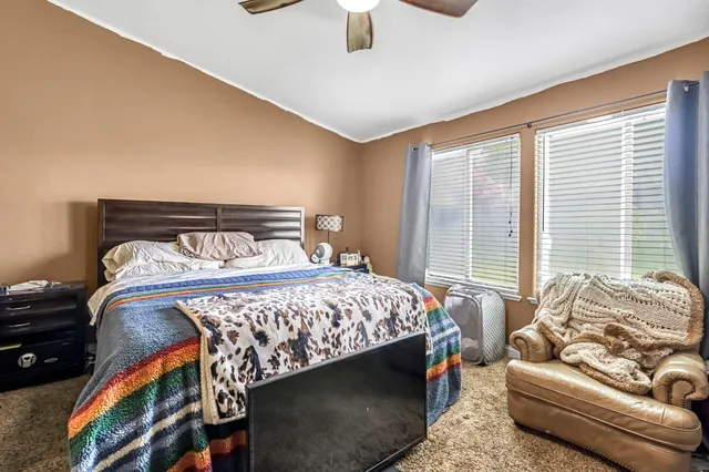 a bedroom with a bed and glass window