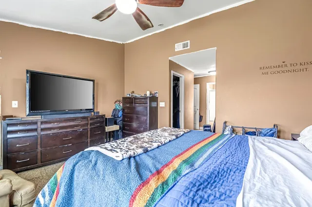 a bedroom with a bed and a flat screen tv