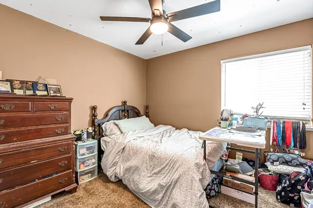 a bed room with a bed and a book shelf