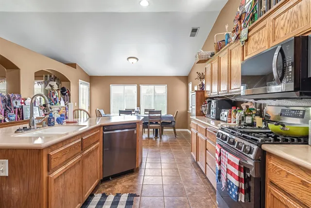 a kitchen with stainless steel appliances a sink stove and cabinets