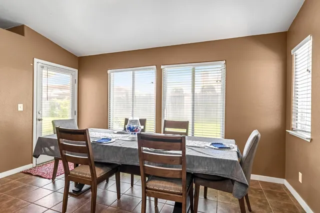 a view of a dining room with furniture and window