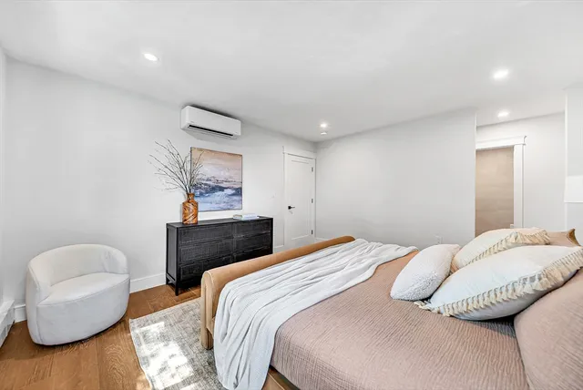 a bedroom with a bed and a chair