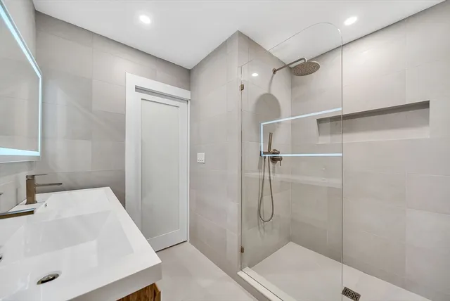 a bathroom with a sink and shower