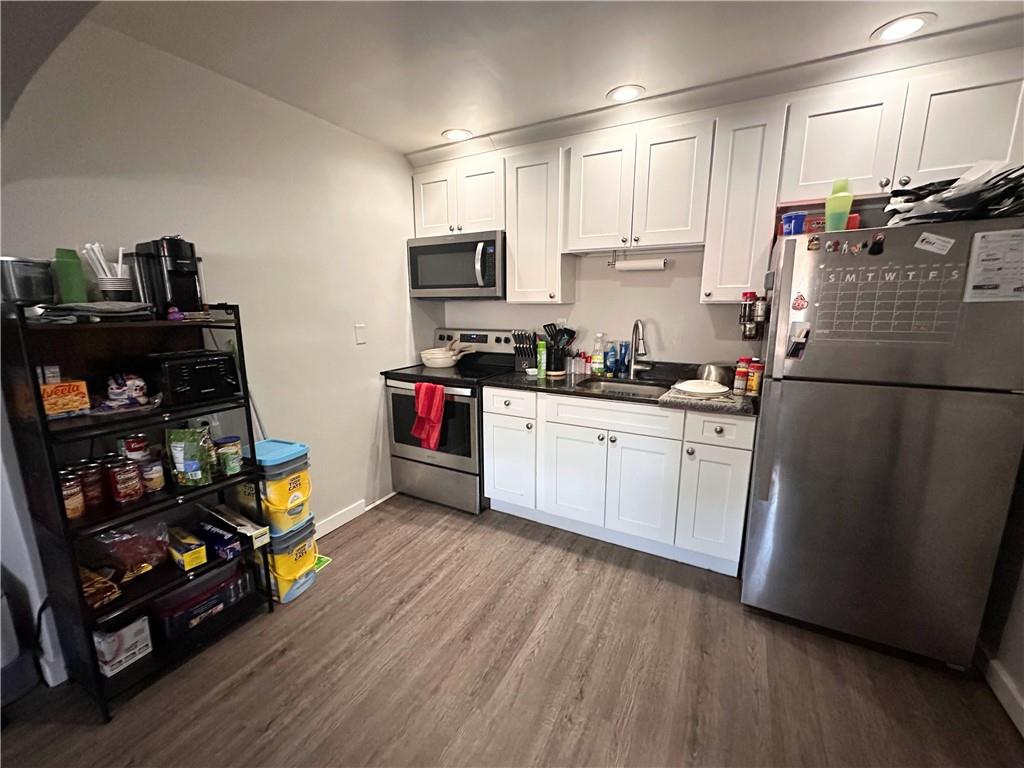 422 Mill Street, Unit D Coraopolis, PA 15108 - Photo 2 of 6 a kitchen with stainless steel appliances granite countertop a refrigerator and a stove top oven