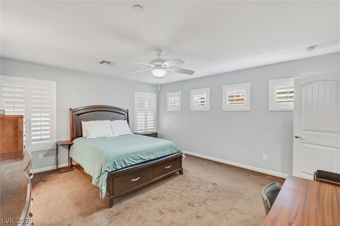 48 Jasmine Point Street Henderson, NV 89074 - Photo 38 of 62 Well-lit sleeping quarters featuring elegant window shutters and comfortable carpeting for quiet repose.