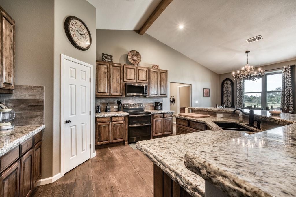 22273 Chapman Road Hempstead, TX 77445 - Photo 14 of 49 a kitchen with stove a refrigerator and a stove