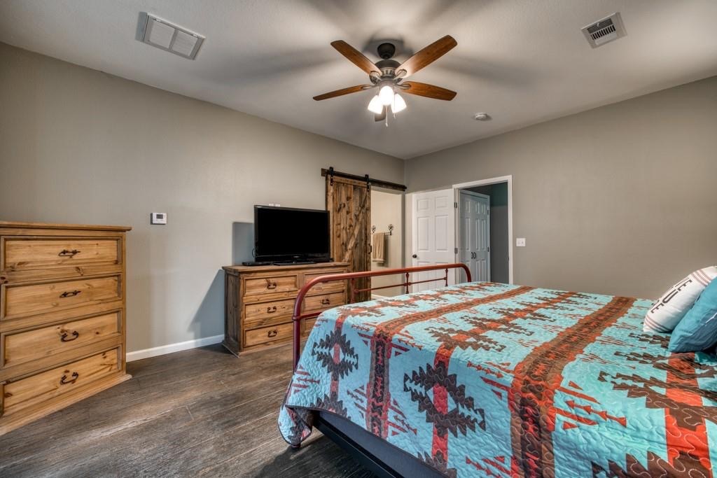 22273 Chapman Road Hempstead, TX 77445 - Photo 16 of 49 a bedroom with a bed and a flat screen tv