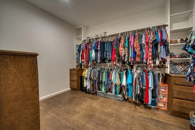 a bathroom with a granite countertop sink toilet and mirror