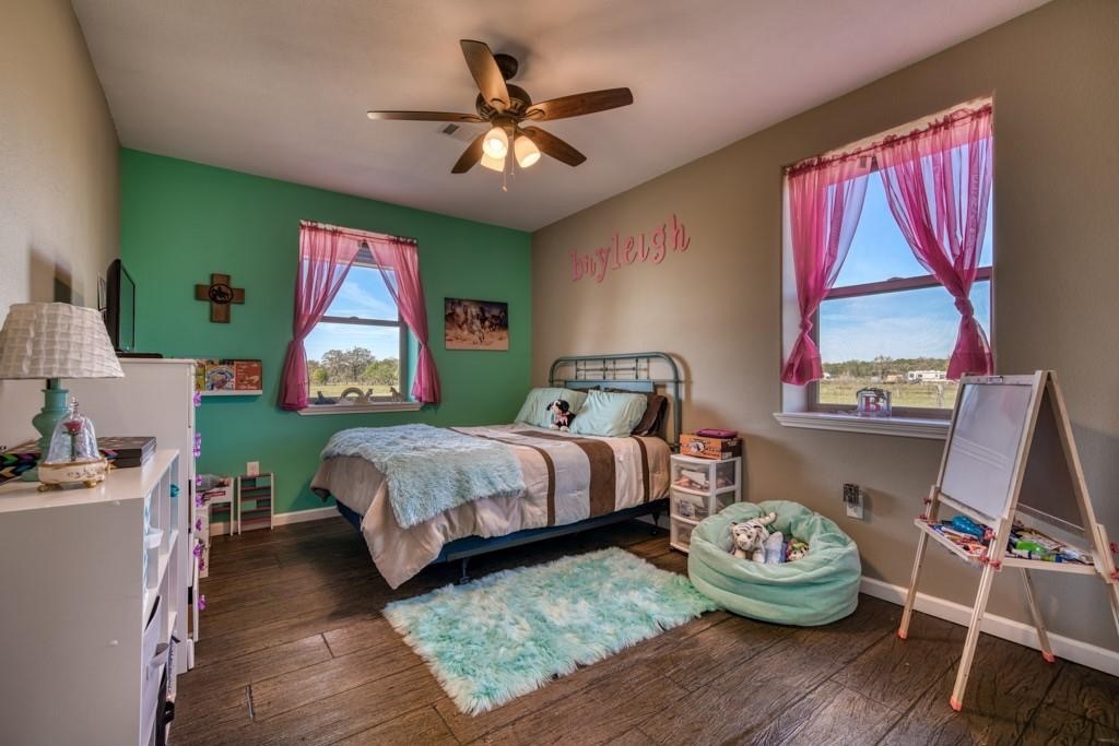 22273 Chapman Road Hempstead, TX 77445 - Photo 21 of 49 a bedroom with a bed and wooden floor