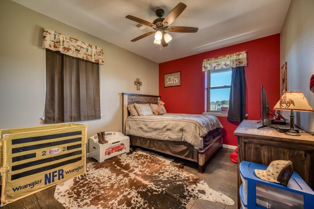 22273 Chapman Road Hempstead, TX 77445 - Photo 22 of 49 a bedroom with a bed and a chandelier