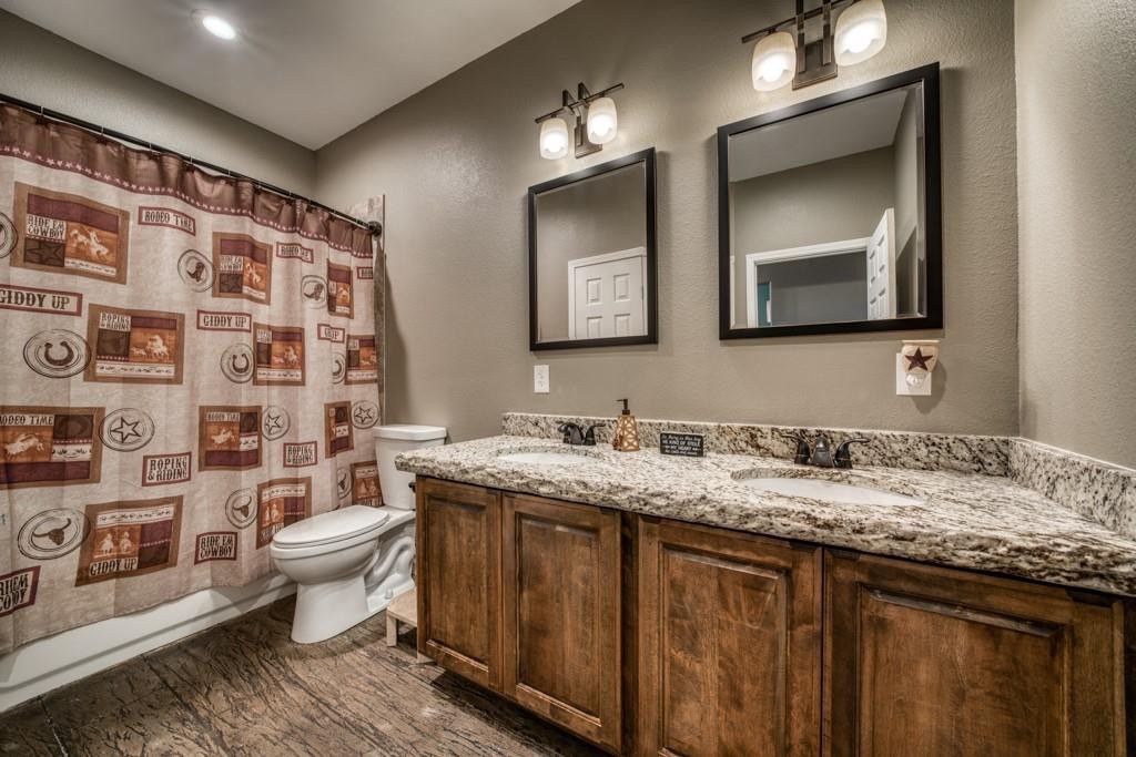 22273 Chapman Road Hempstead, TX 77445 - Photo 24 of 49 a bathroom with a granite countertop sink toilet and mirror