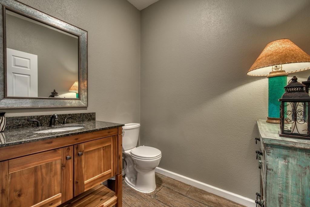 22273 Chapman Road Hempstead, TX 77445 - Photo 25 of 49 a bathroom with a toilet a sink and mirror