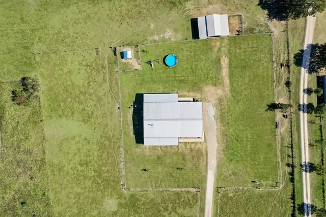 a house view with swimming pool in front of it