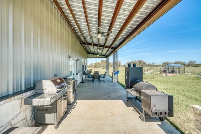a view of a field with an trees in the background