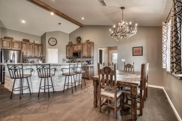 a kitchen with a stove sink and cabinets