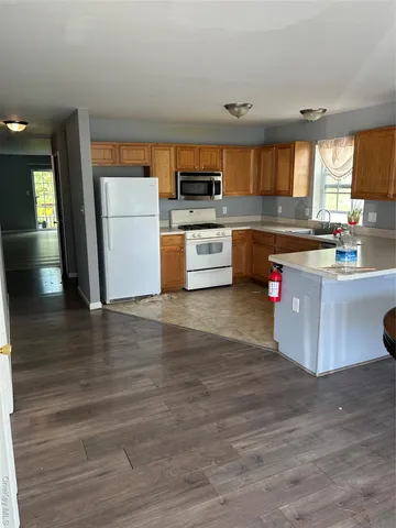 a kitchen with stainless steel appliances a refrigerator and a stove top oven