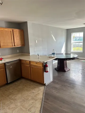 a kitchen with a sink window and cabinets
