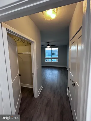 a view of empty room with wooden floor