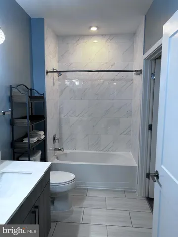 a bathroom with a bathtub a toilet and a shower