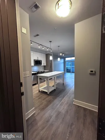 wooden floor with a kitchen