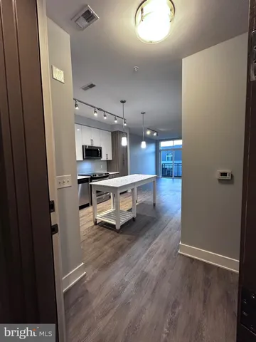 wooden floor with a kitchen
