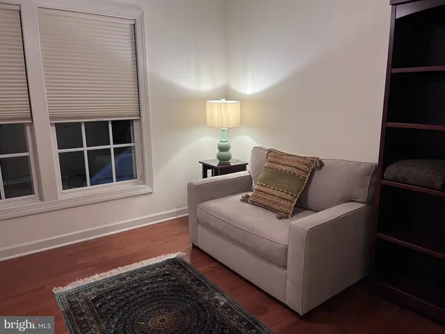a white bed sitting in a bedroom next to a window