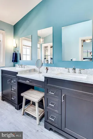 a sink with a cabinets and chair