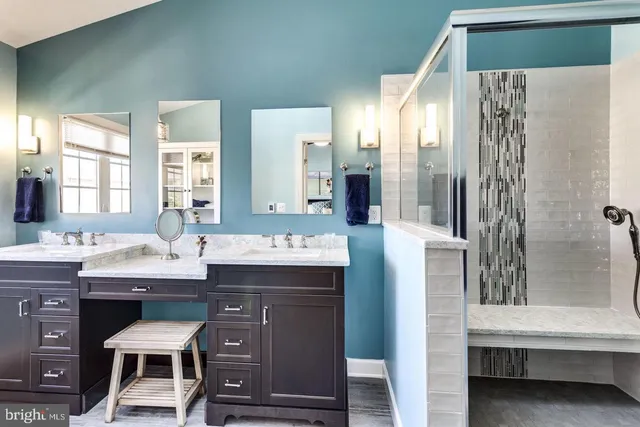 a spacious bathroom with a granite countertop sink and a mirror