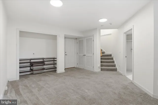 an empty room with stairs and a window