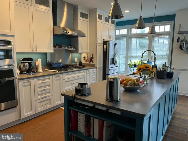 a kitchen with a sink a stove and cabinets