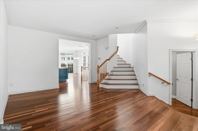 a view of entryway and hall with wooden floor