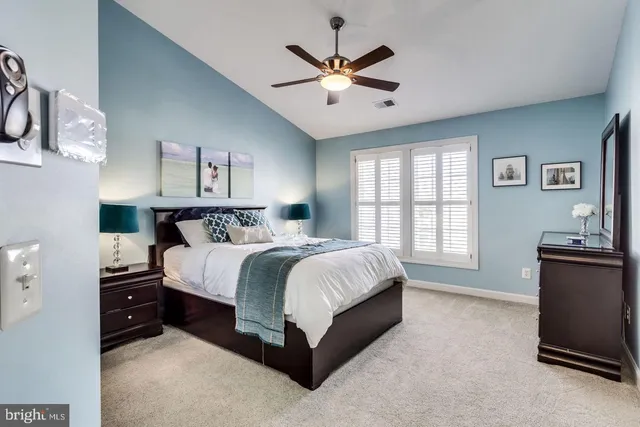 a spacious bedroom with a bed and a table