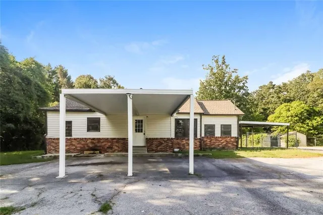 a view of a house with a backyard and porch