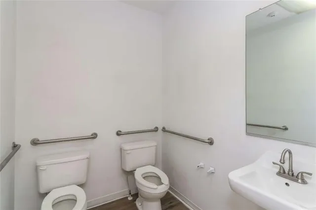 a white toilet sitting next to a bathroom sink