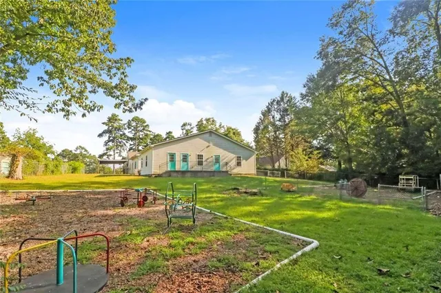a view of a house with a yard and sitting area
