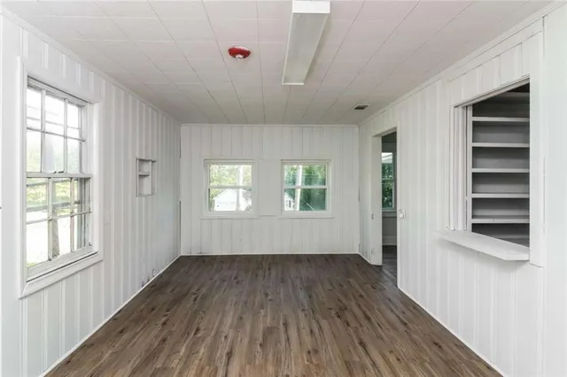 wooden floor in an empty room with a window